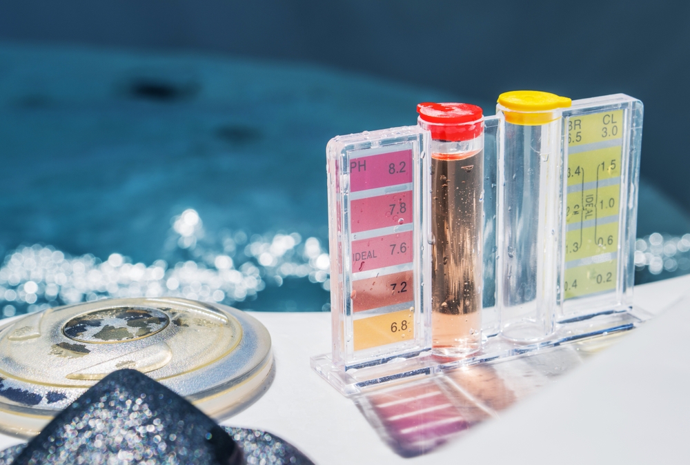 Pool water testing kit with color-coded pH and chlorine test tubes, highlighting water chemistry for safety compliance in aquatic facilities.