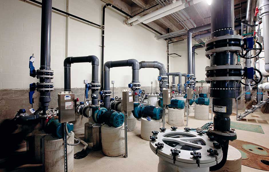 commercial pool mechanical room — pumps, filtration equipment, and control panels