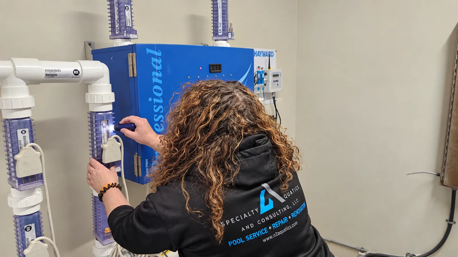 Commercial salt chlorine generator cell being inspected for calcium buildup